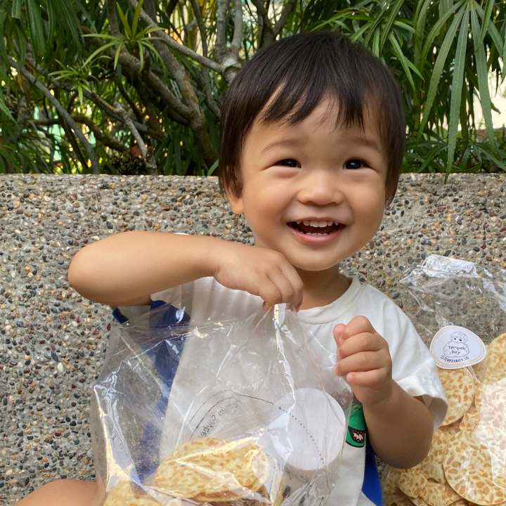 tempeh boy holding a bag of tempe chips