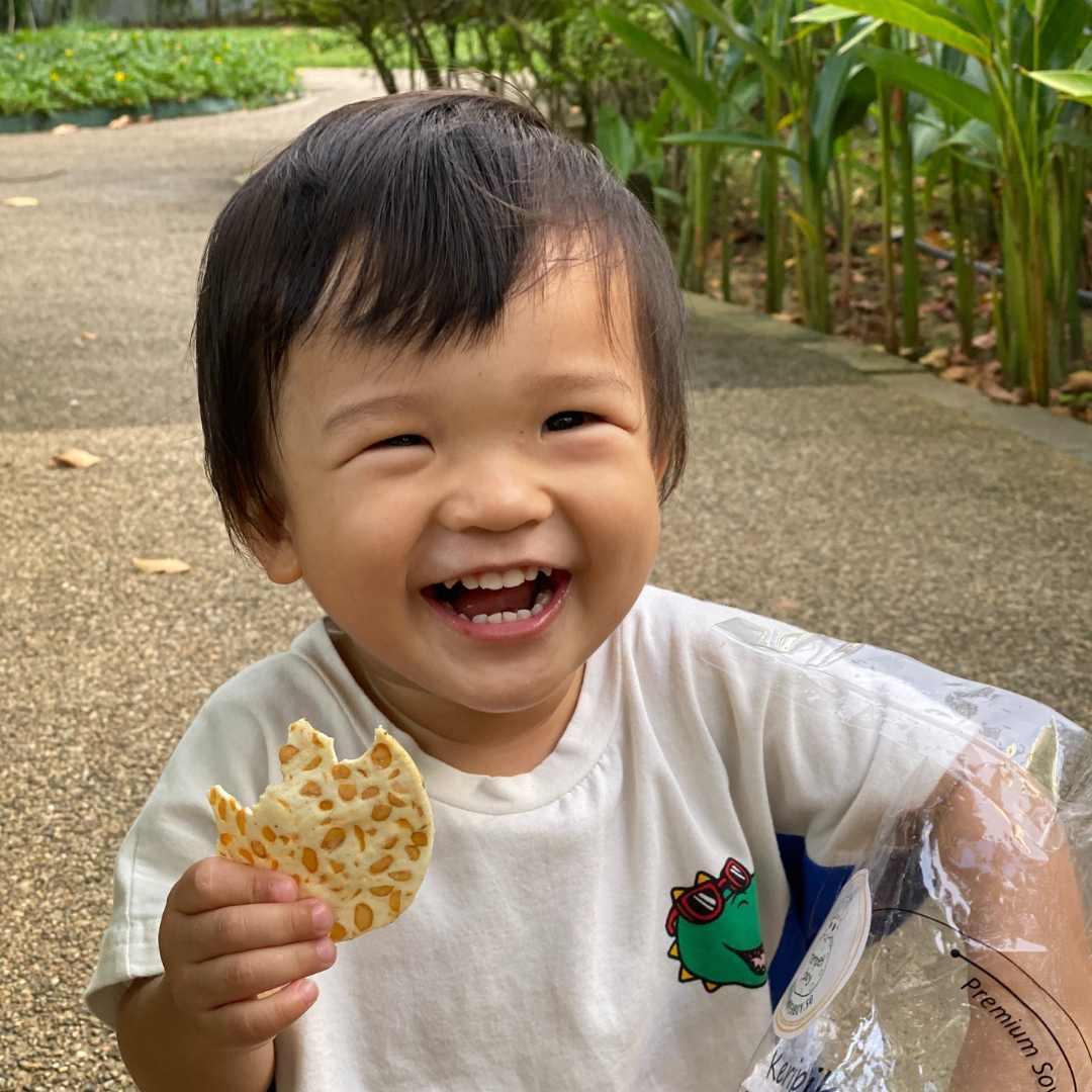 cute tempeh boy eating tempeh chips